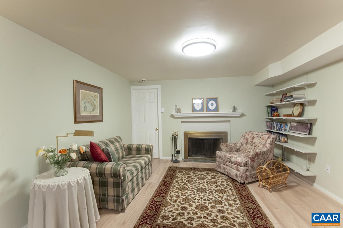 2306 Tarleton Drive Charlottesville, VA 22901 - Photo 30 of 35 a living room with furniture and a fireplace