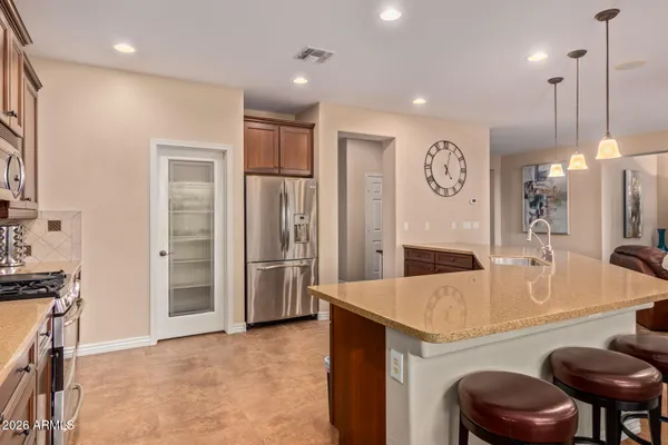 a large kitchen with a table and chairs