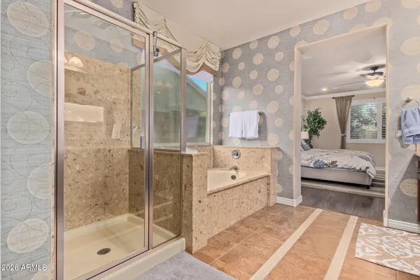 a bathroom with a glass door shower and a sink