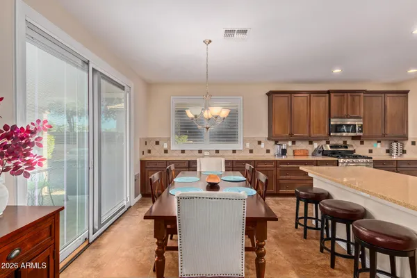 a dining table chairs and chandelier in kitchen