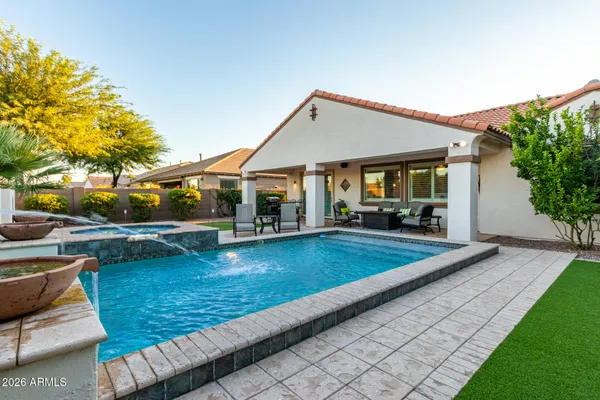 a view of a house with swimming pool and sitting area