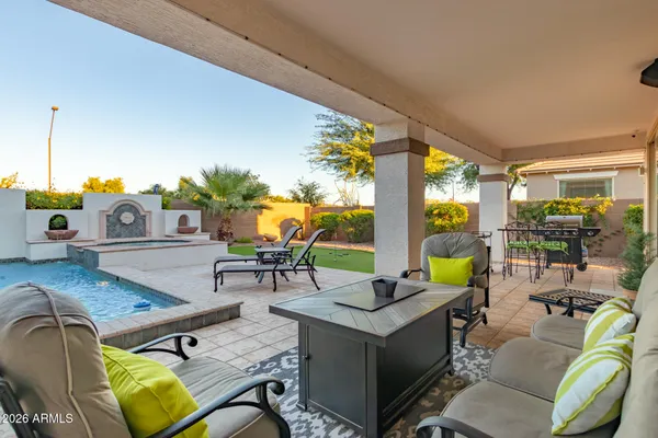 a living room with patio furniture and a floor to ceiling window