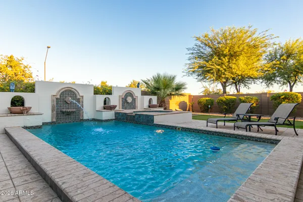 a view of a house with backyard and sitting area