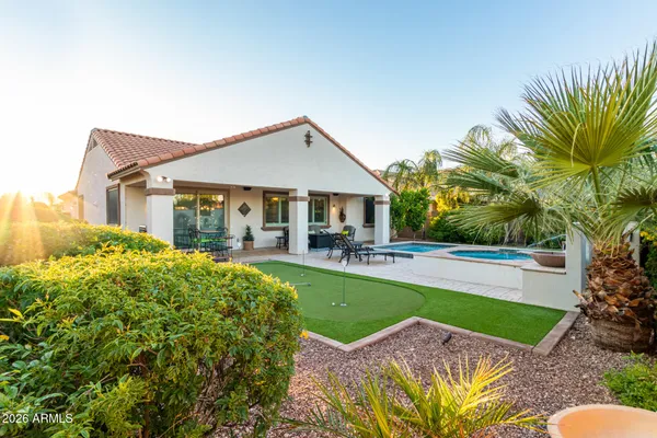 a front view of a house with swimming pool having outdoor seating