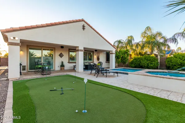 a view of a house with a backyard porch and sitting area