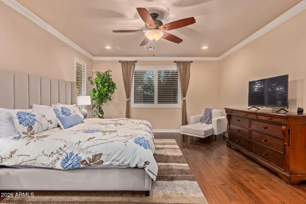 a bedroom with a bed and wooden floor