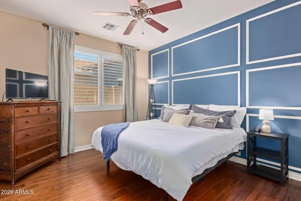 a bedroom with a bed and wooden floor