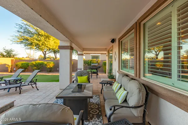 a balcony with chairs and a table