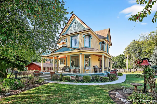 a front view of a house with a yard and potted plants