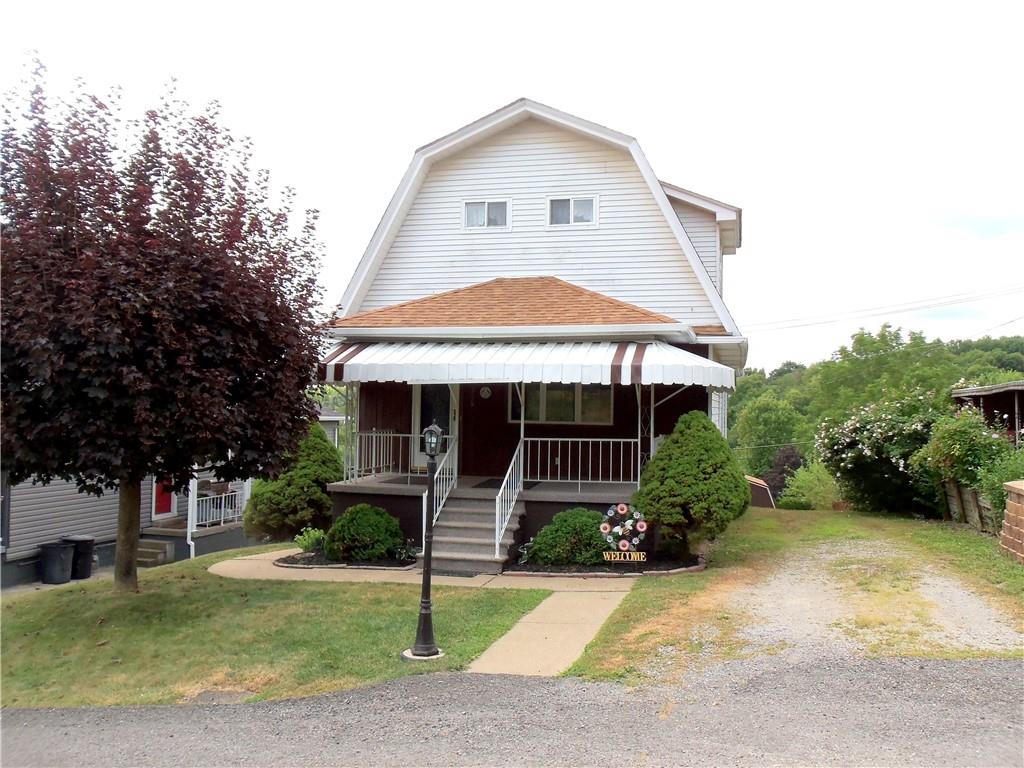 306 Silver Maple Avenue Langeloth, PA 15054 - Photo 2 of 31 a front view of a house with garden