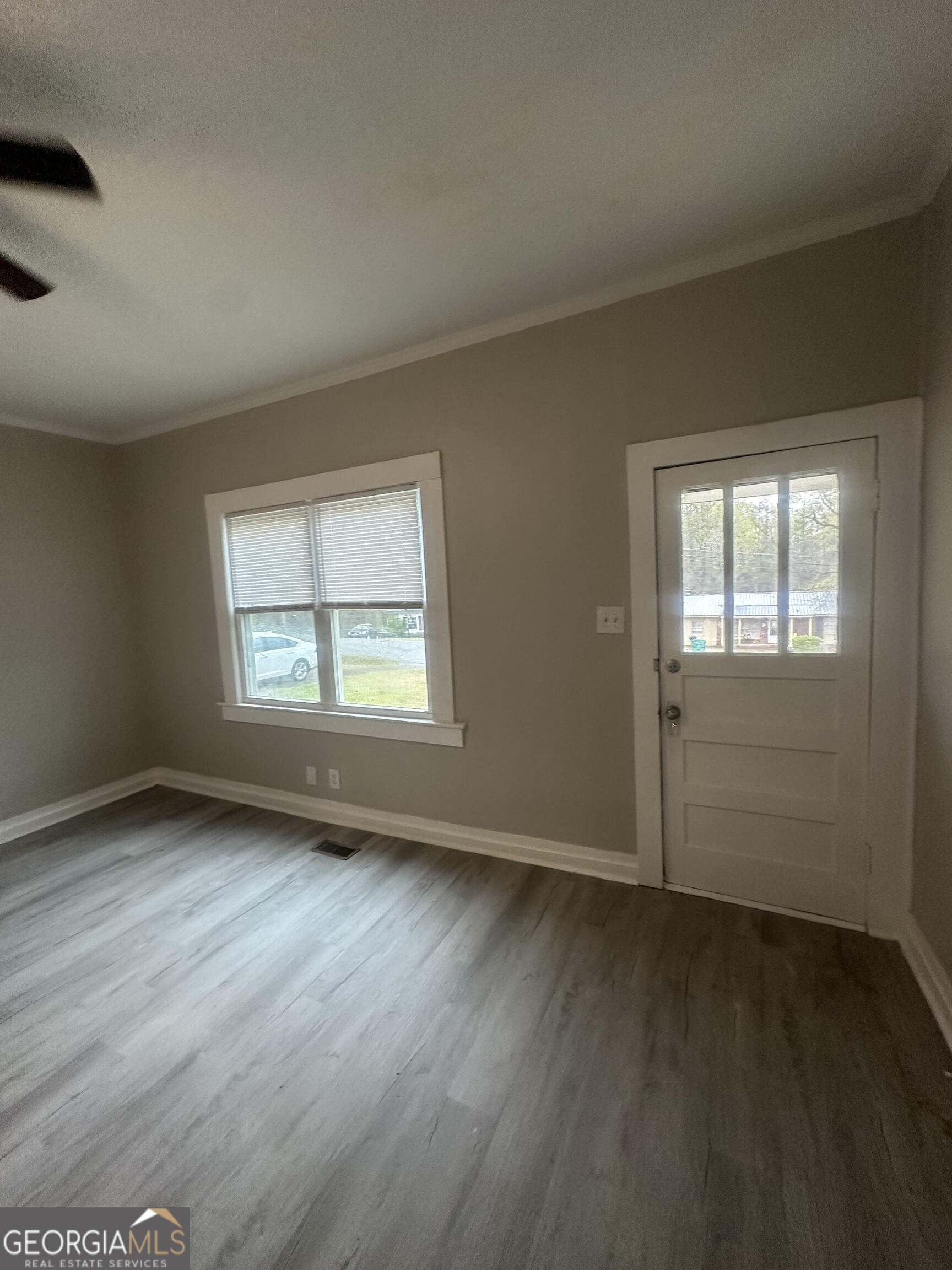 193 Frazier Drive Southeast Milledgeville, GA 31061 - Photo 23 of 38 an empty room with wooden floor and windows