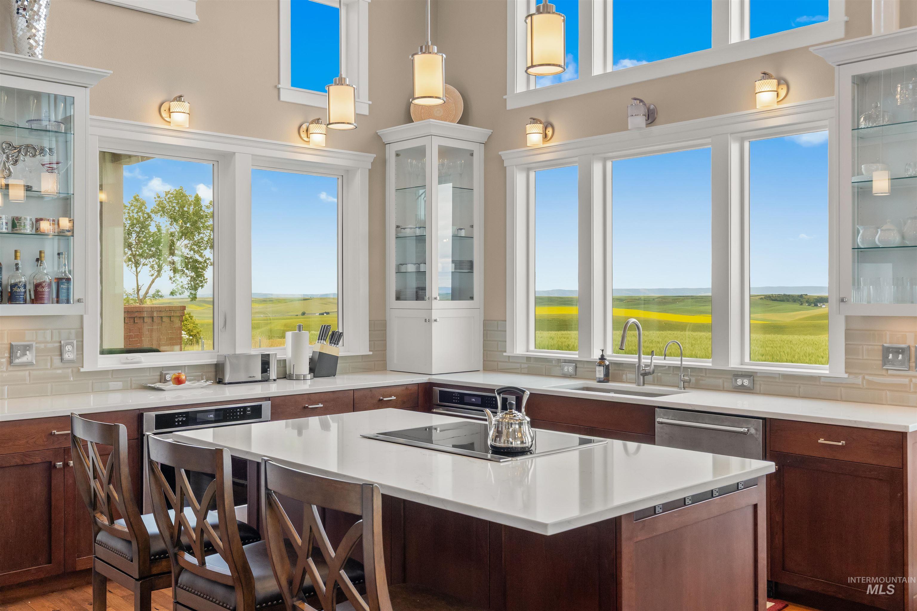 1513 Uniontown Road Genesee, ID 83832 - Photo 25 of 50 Recessed lighting and a decorative ceiling fixture illuminate this room featuring wood-finish flooring, a large window with transom, and white trim