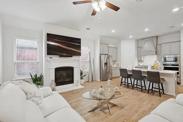 a kitchen with stainless steel appliances kitchen island granite countertop a sink refrigerator and cabinets