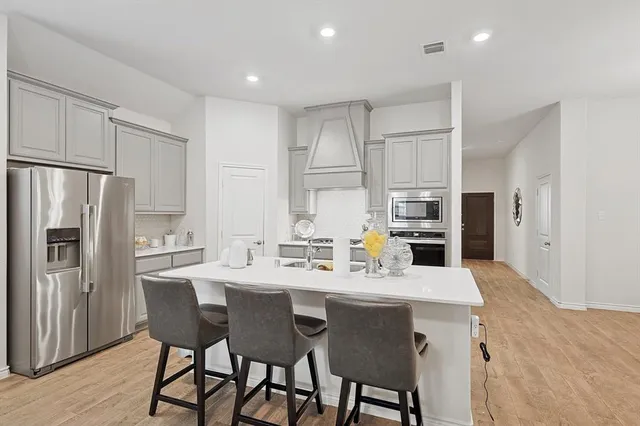 a kitchen with a sink appliances and cabinets