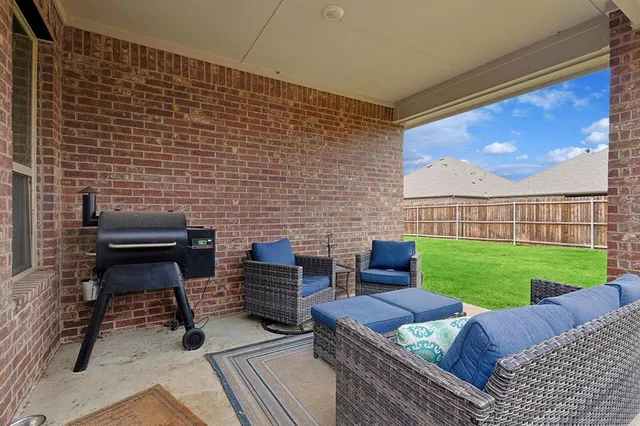 a view of a backyard with potted plants and wooden fence