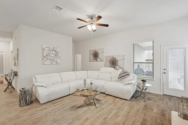 a living room with furniture kitchen view and a dining table