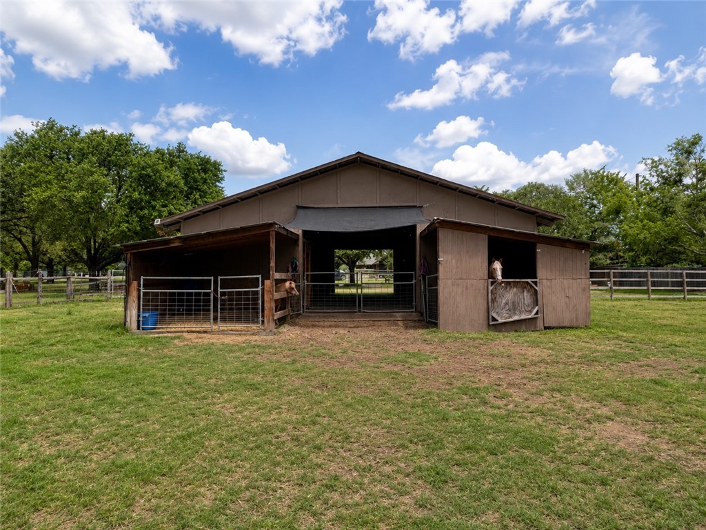 2302 Quail Run College Station, TX 77845 - Photo 34 of 49 a front view of a house with a garden and trees