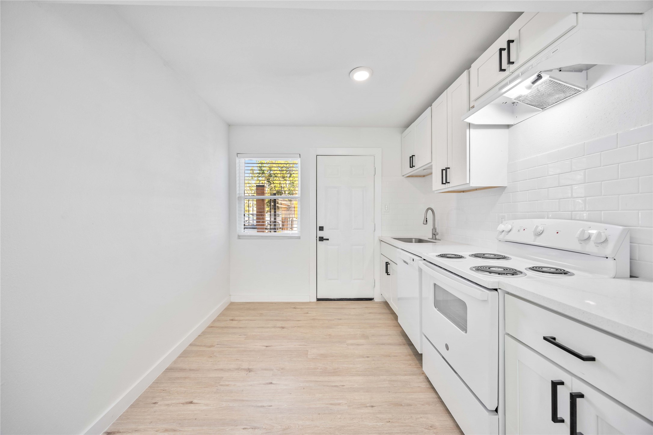 6811 Del Rio Street, Unit 26 Houston, TX 77021 - Photo 2 of 18 a kitchen with a stove top oven sink and cabinets