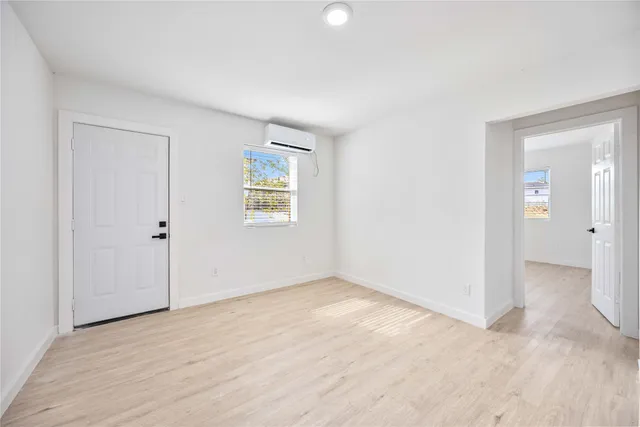 an empty room with windows and closet