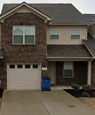 a front view of a house with garage