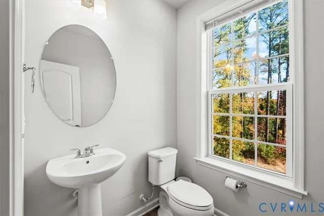 a bathroom with a sink a mirror and a toilet