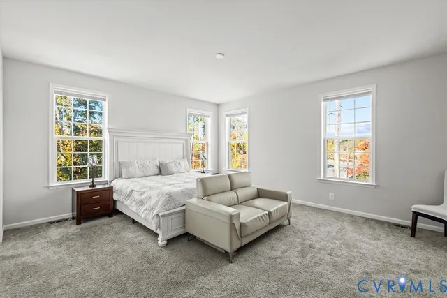 a spacious bedroom with a bed and a window