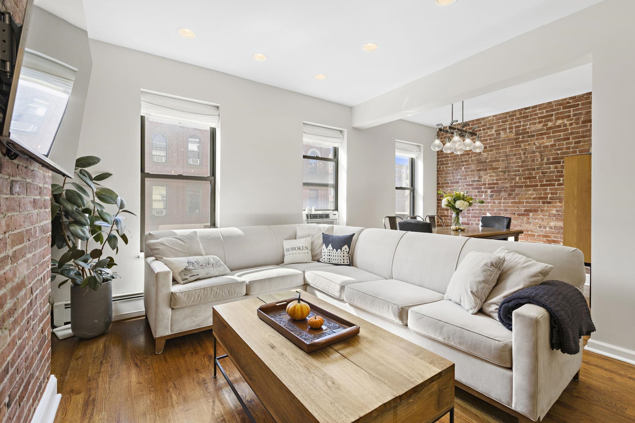 a living room with furniture and a flat screen tv