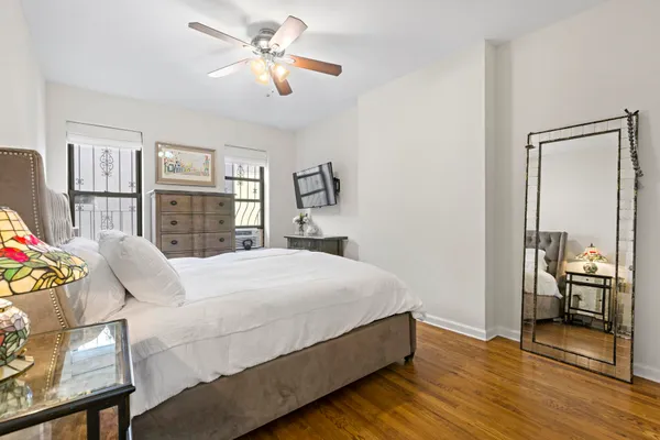 a bedroom with a large bed and a chandelier