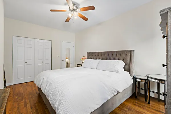 a bedroom with a bed and a chandelier