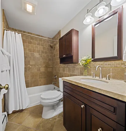 a bathroom with a granite countertop sink toilet a large mirror and shower