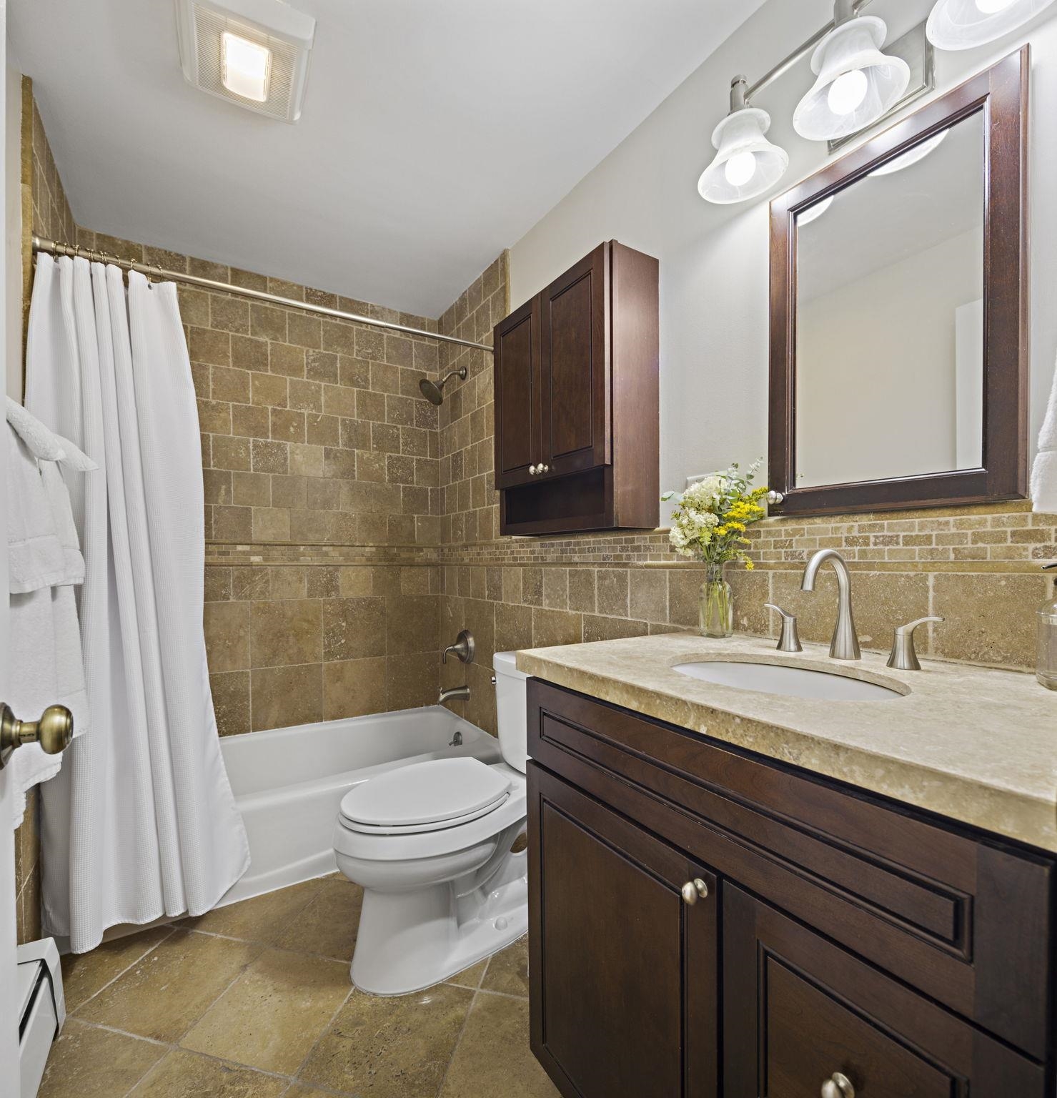 262 1st Street, Unit D Hoboken, NJ 07030 - Photo 15 of 19 a bathroom with a granite countertop sink toilet a large mirror and shower
