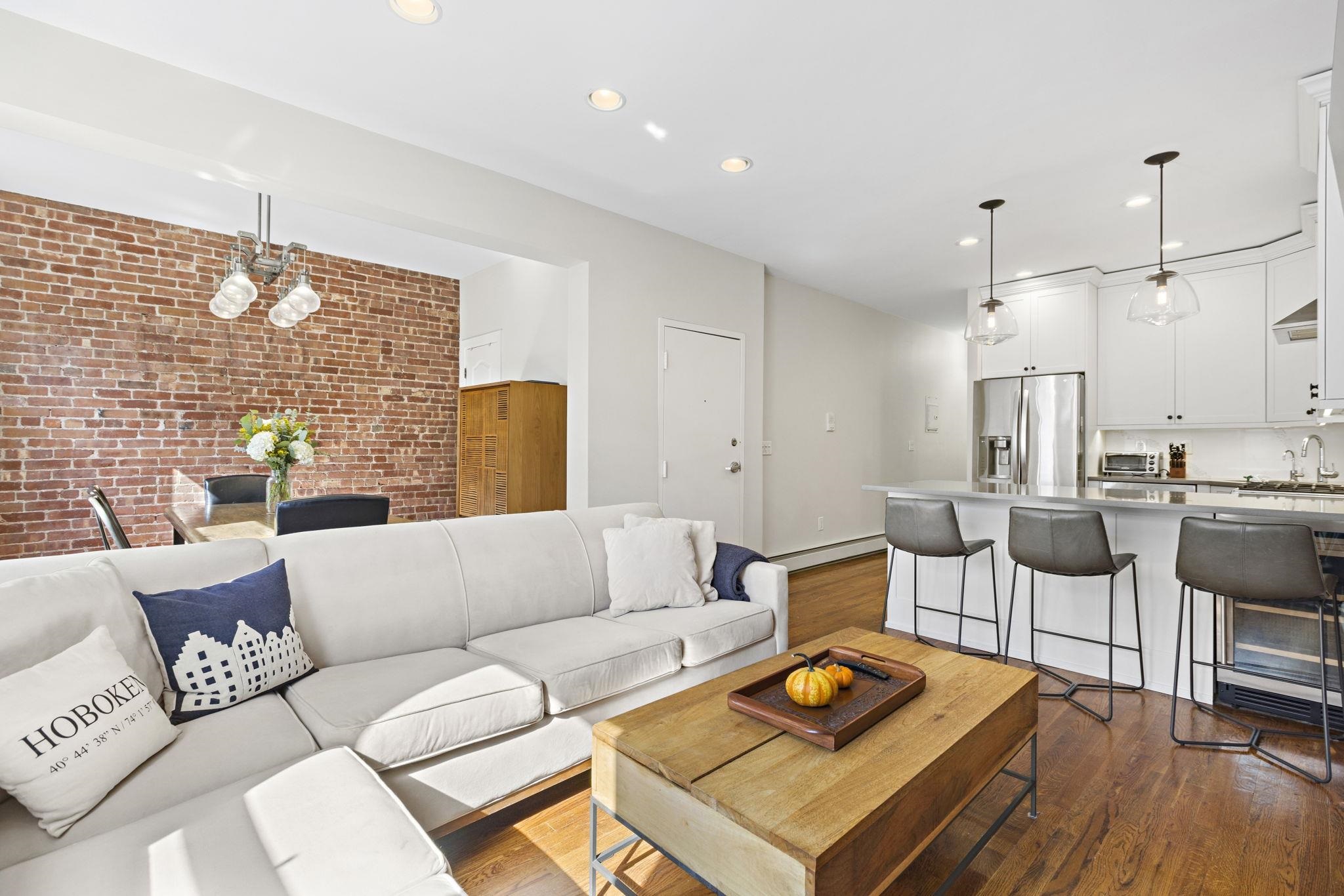 262 1st Street, Unit D Hoboken, NJ 07030 - Photo 2 of 19 a living room with furniture and a wooden floor