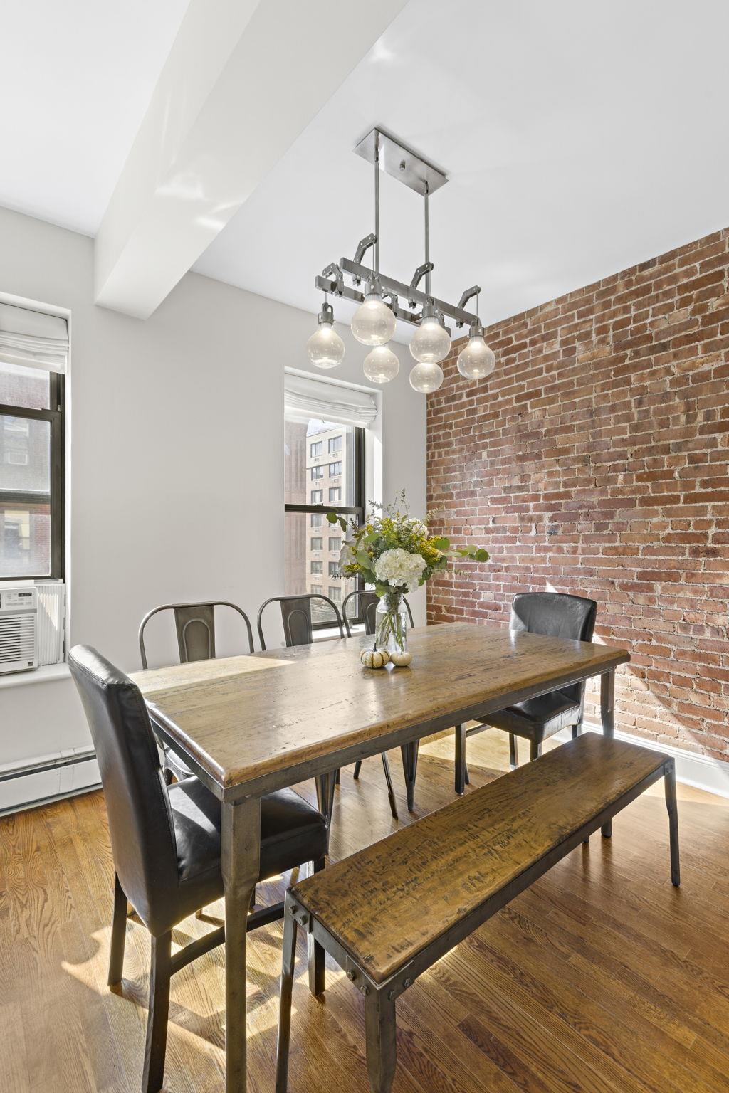 262 1st Street, Unit D Hoboken, NJ 07030 - Photo 9 of 19 a view of a dining room with furniture and wooden floor