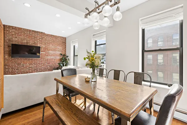 a view of a dining room with furniture window and wooden floor