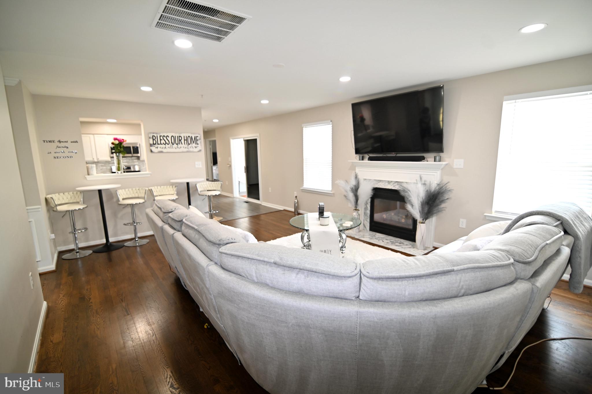 6009 Sellner Lane Clinton, MD 20735 - Photo 17 of 61 a living room with furniture fireplace and a flat screen tv