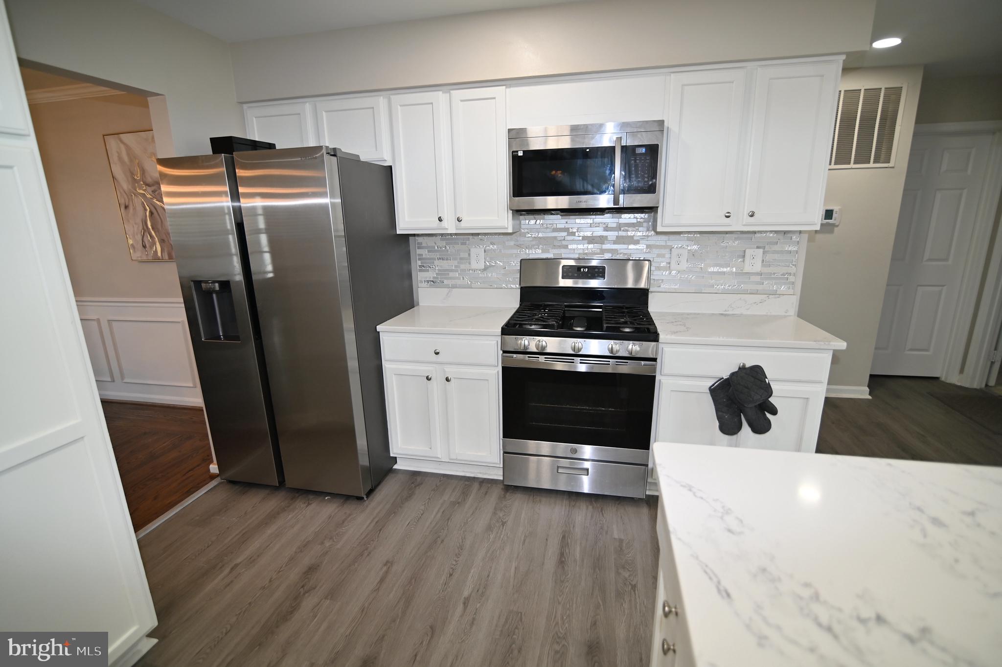 6009 Sellner Lane Clinton, MD 20735 - Photo 21 of 61 a kitchen with stainless steel appliances a refrigerator stove and microwave