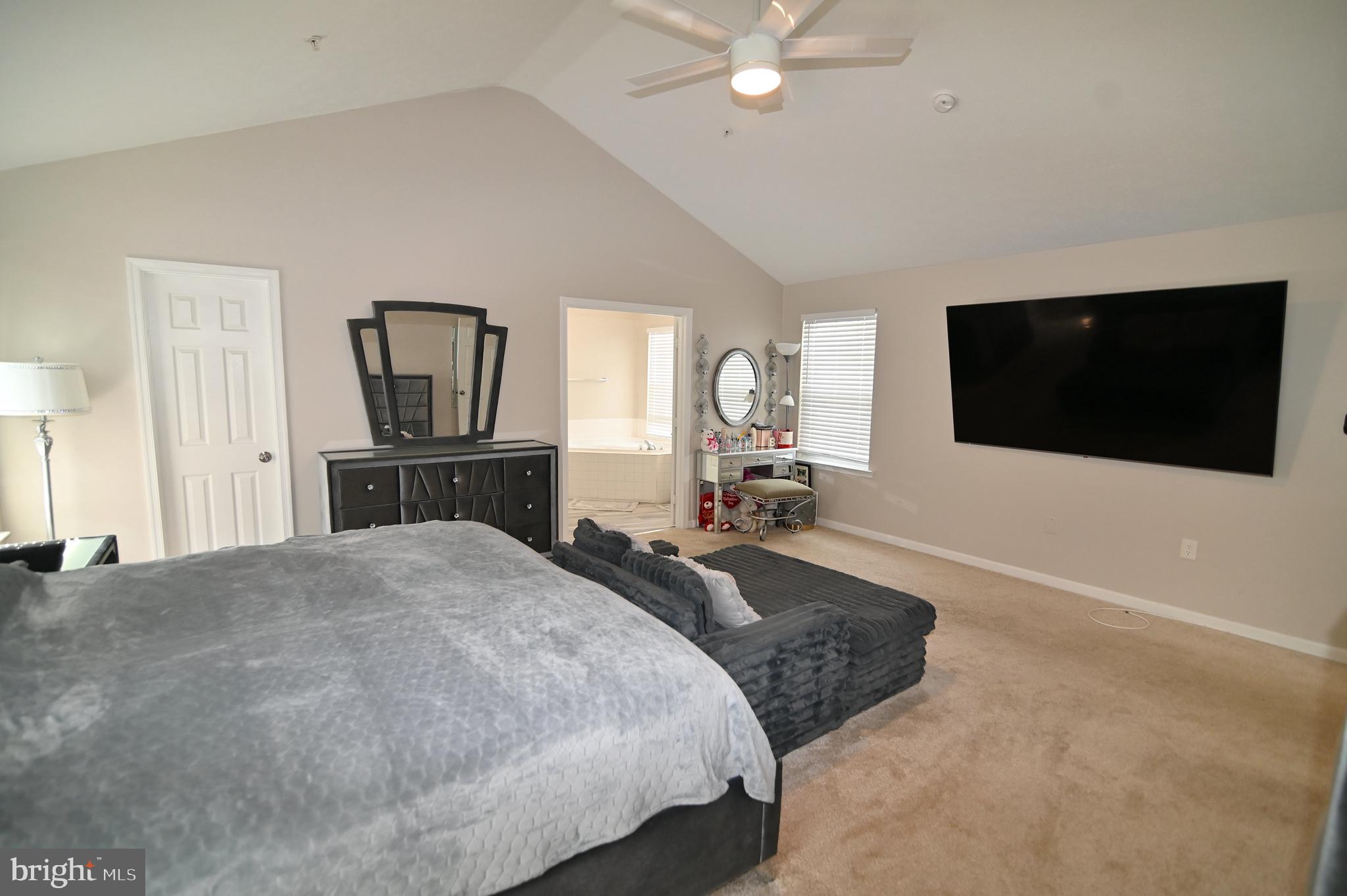 6009 Sellner Lane Clinton, MD 20735 - Photo 31 of 61 a spacious bedroom with a bed and a flat screen tv