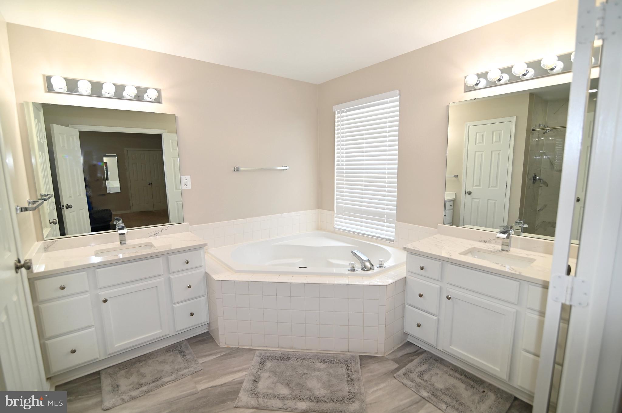 6009 Sellner Lane Clinton, MD 20735 - Photo 32 of 61 a bathroom with a double vanity sink mirror and bathtub
