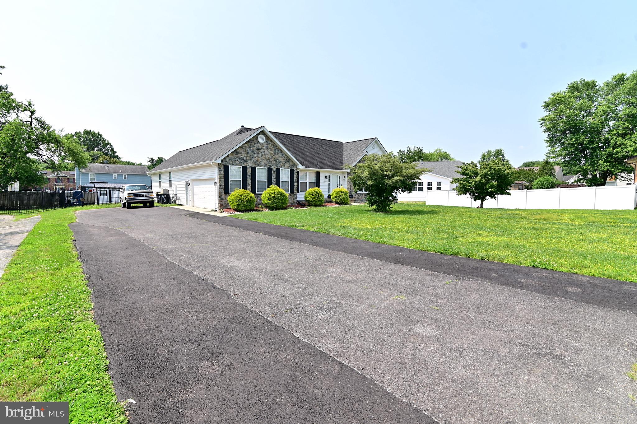 6009 Sellner Lane Clinton, MD 20735 - Photo 4 of 61 a front view of a house with a yard and garage