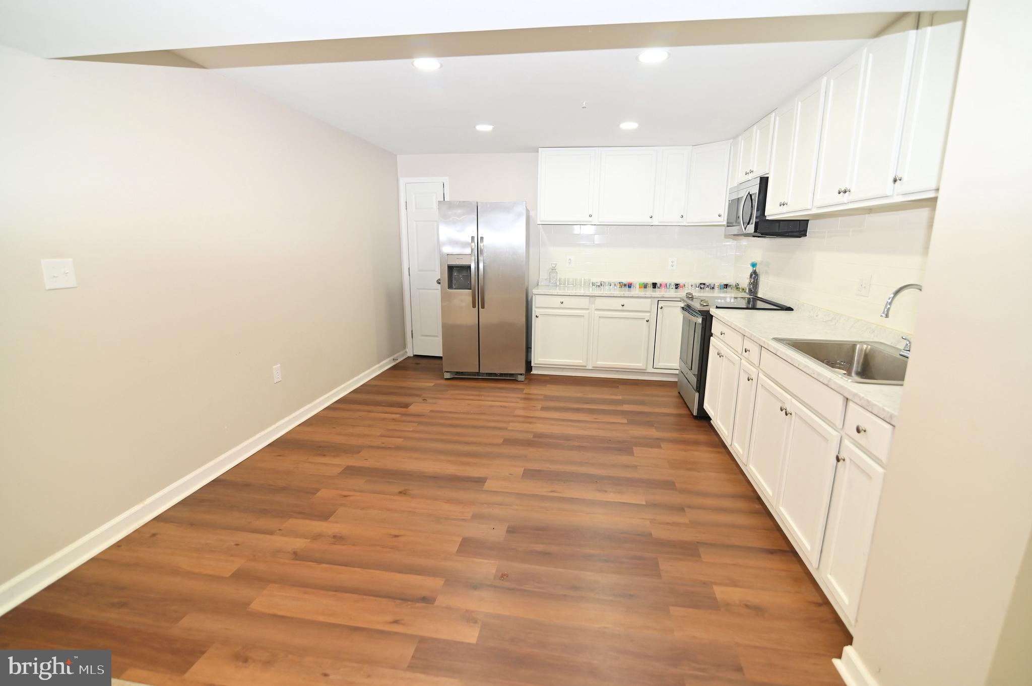 6009 Sellner Lane Clinton, MD 20735 - Photo 43 of 61 a kitchen with white cabinets appliances and a window