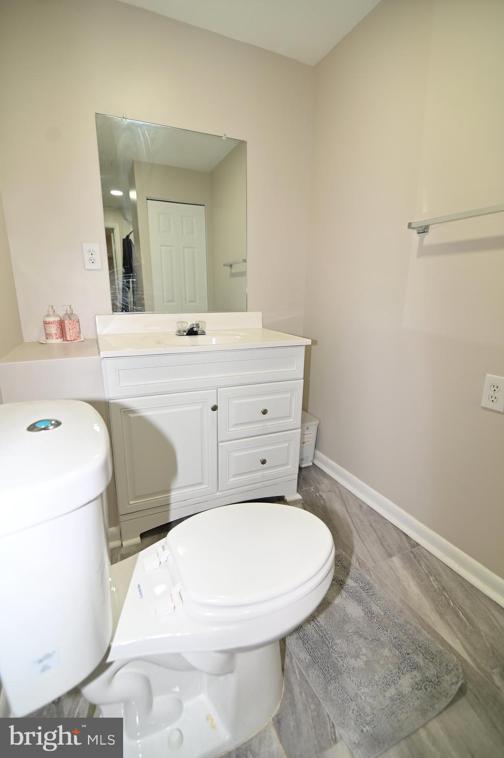 6009 Sellner Lane Clinton, MD 20735 - Photo 56 of 61 a bathroom with a toilet sink and mirror