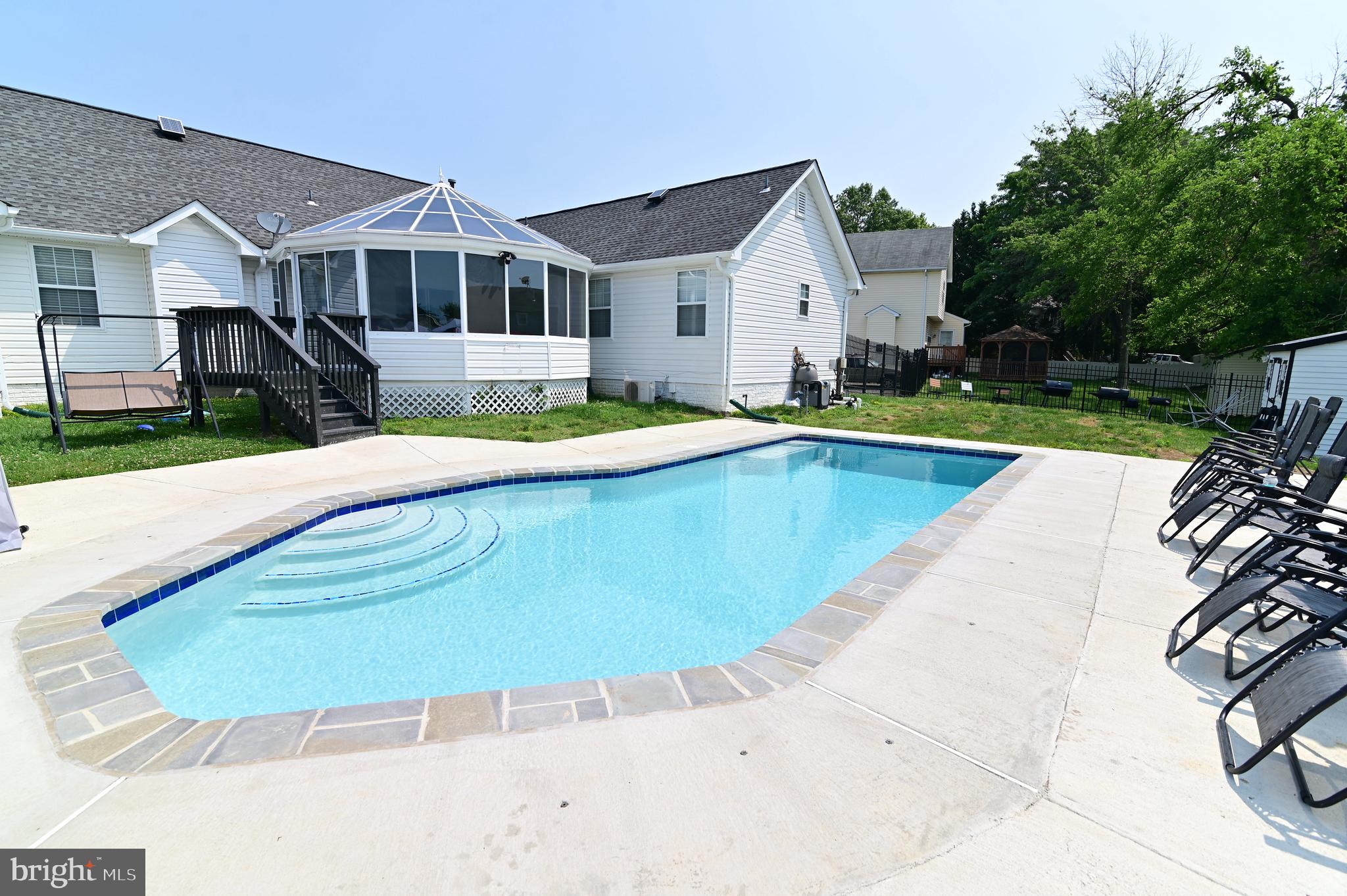 6009 Sellner Lane Clinton, MD 20735 - Photo 60 of 61 a view of a white house with a swimming pool and a yard
