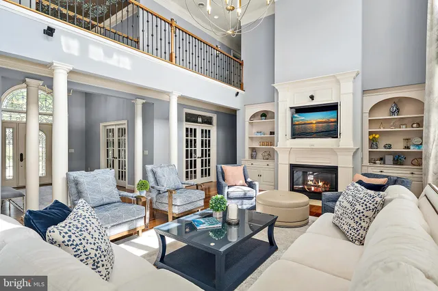 a living room with a table chairs and a dining table