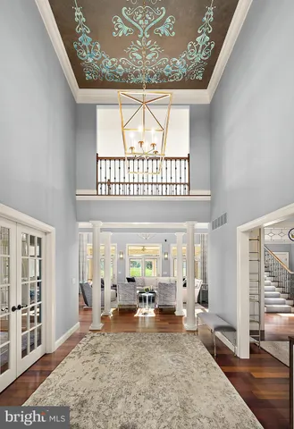 a living room with fireplace furniture and a chandelier