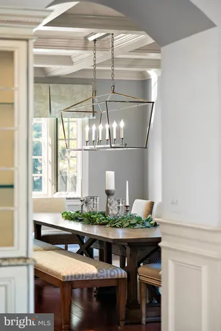 a living room with furniture a flat screen tv and kitchen view