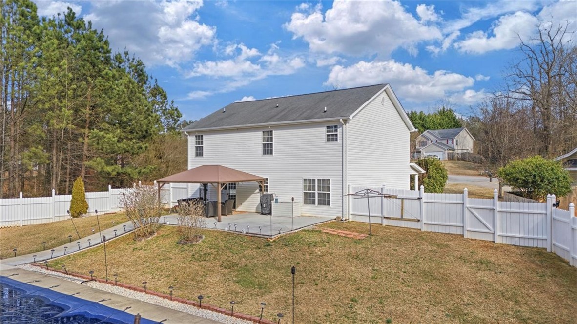 102 Tc-2-168 Pendleton, SC 29670 - Photo 32 of 44 This spacious backyard features a patio area and private pool, ideal for outdoor entertaining.
