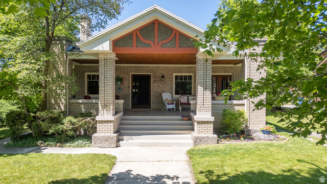 Undisclosed Address Logan, UT 84321 - Photo 1 of 1 Craftsman-style home featuring a brick exterior, prominent front porch, and detailed gable trim