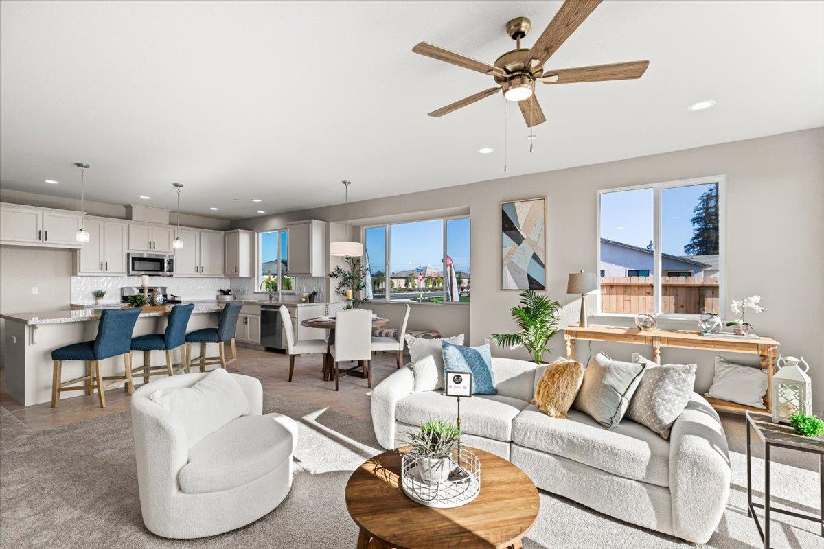 2970 East Tuolumne Road Turlock, CA 95382 - Photo 34 of 68 a living room with furniture kitchen view and a chandelier