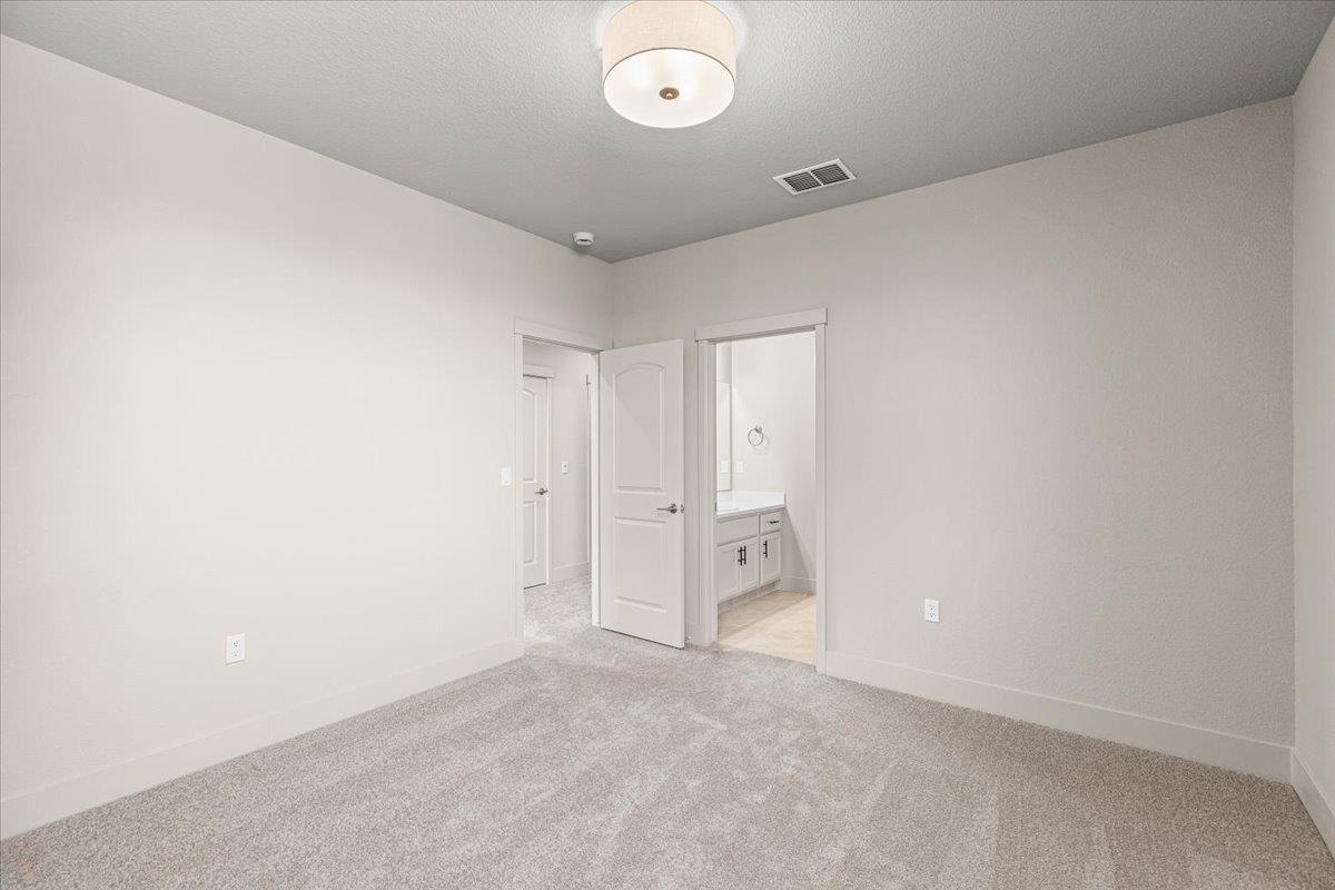 2970 East Tuolumne Road Turlock, CA 95382 - Photo 51 of 68 Unfurnished bedroom featuring light colored carpet and ensuite bath