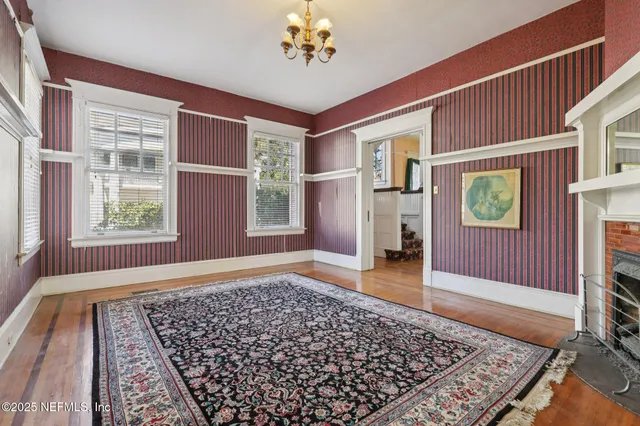 a kitchen with granite countertop white cabinets and wooden floor